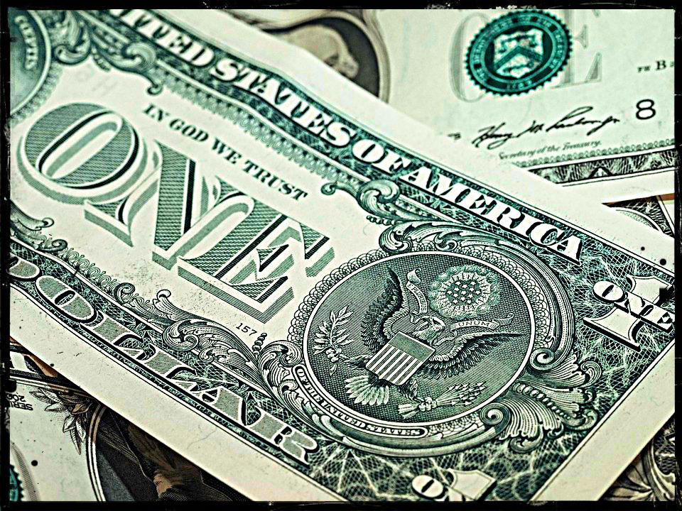 dollar bills lying on top of each other